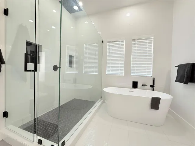 a spacious bathroom with a tub and a shower