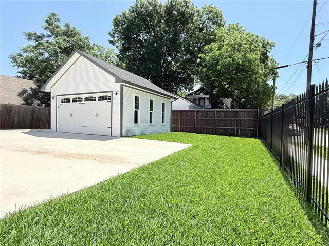 a view of a house with a yard and a garden