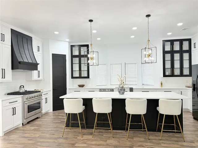 a large kitchen with a table and chairs