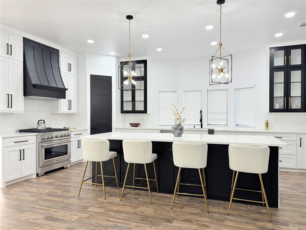 4602 Sycamore Street Dallas, TX 75204 - Photo 4 of 24 a kitchen with stainless steel appliances kitchen island granite countertop a dining table chairs and sink