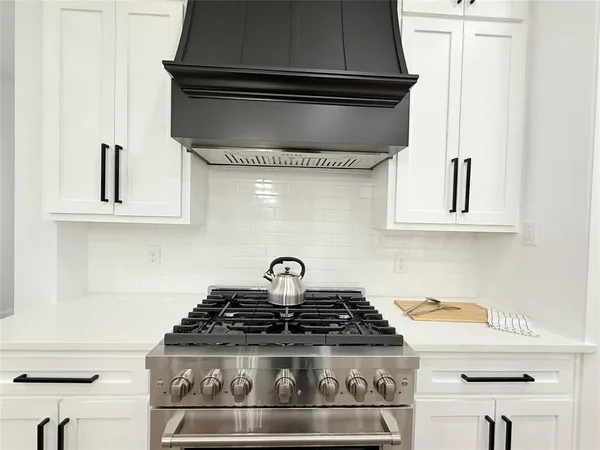 a stove top oven sitting inside of a kitchen