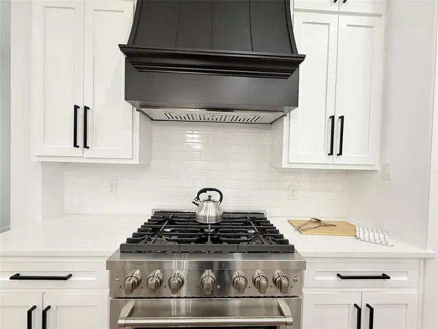 a stove top oven sitting inside of a kitchen