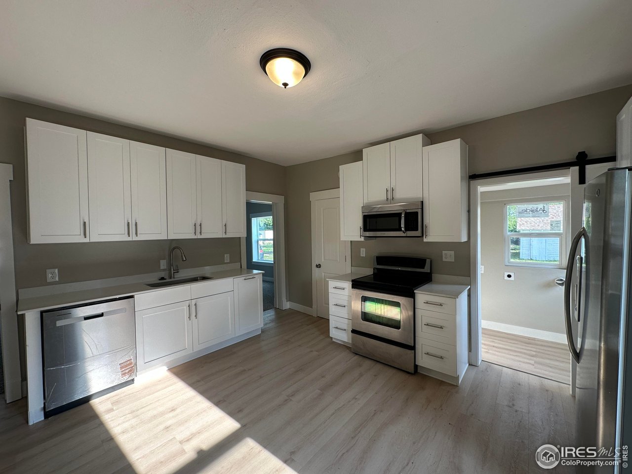 514 Hamilton Street Sterling, CO 80751 - Photo 2 of 12 Kitchen with Quartz counters and Stainless appliances.