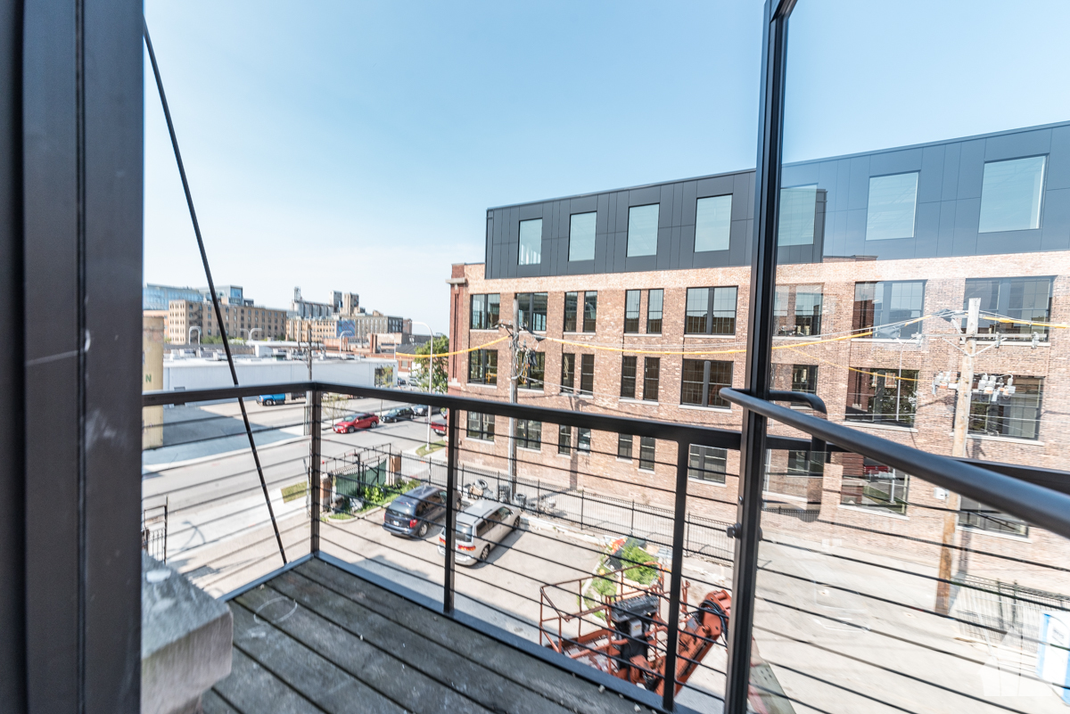 213 North Racine Avenue, Unit 305 Chicago, IL 60607 - Photo 21 of 22 a view of a balcony with wooden floor and iron stairs