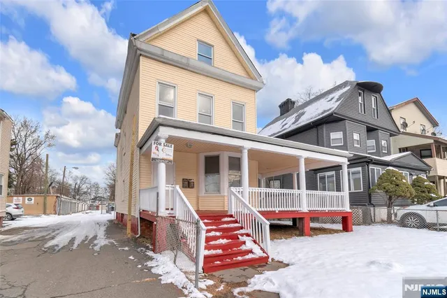 a front view of a house with a garden and barbeque oven