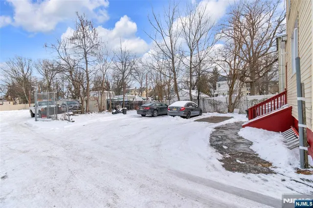 a street view covered with snow and trees