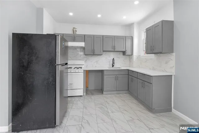 a kitchen with a sink stainless steel appliances and cabinets