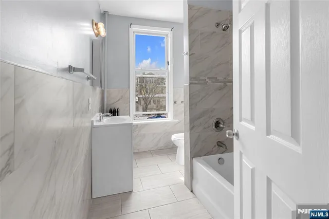 a bathroom with a bathtub a shower a sink and a toilet