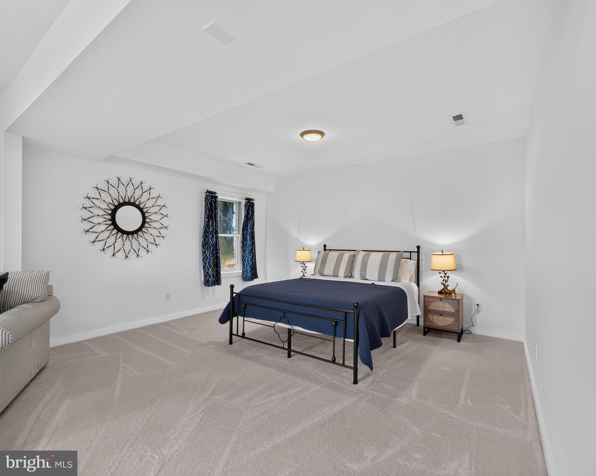 4028 South F T Valley Road Etlan, VA 22719 - Photo 69 of 101 a spacious bedroom with a bed and a couch