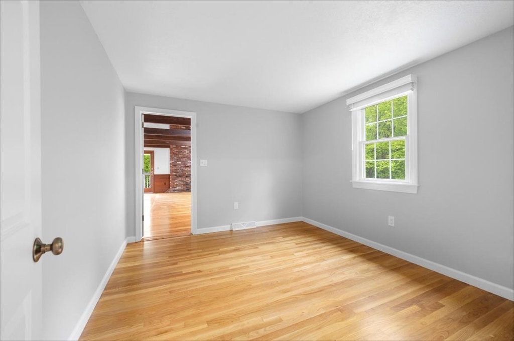 48 Knollwood Road Norwell, MA 02061 - Photo 21 of 41 a view of an empty room with wooden floor and a window