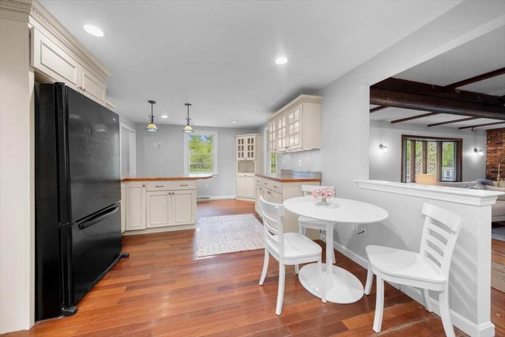 48 Knollwood Road Norwell, MA 02061 - Photo 10 of 41 a kitchen with a dining table chairs and refrigerator