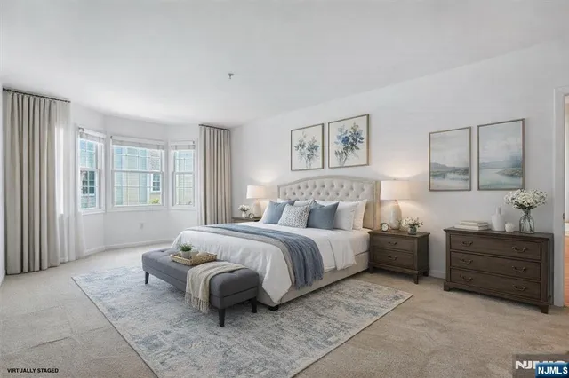 a spacious bedroom with a bed and a window