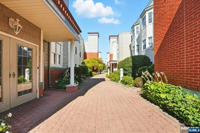 a view of a street with potted plants
