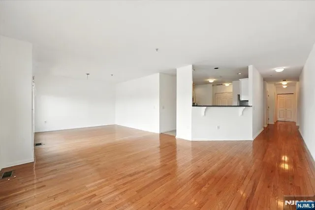 a view of a kitchen with wooden floor and a sink