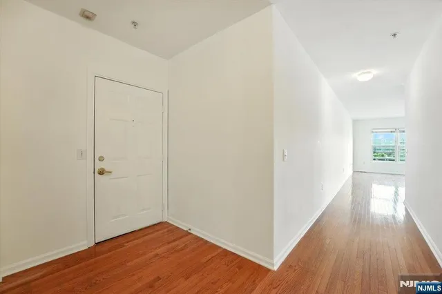 a view of hallway with wooden floor