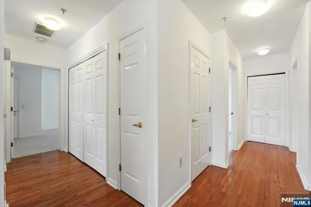 a view of a hallway with wooden floor