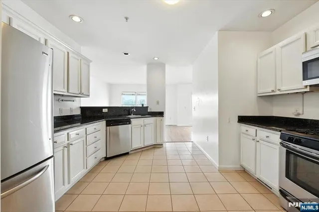 a kitchen with a sink a stove and cabinets