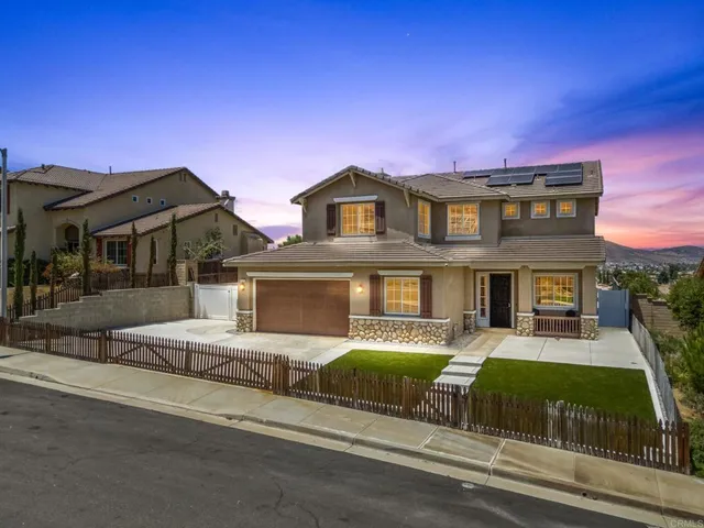 an aerial view of residential houses with outdoor space and parking