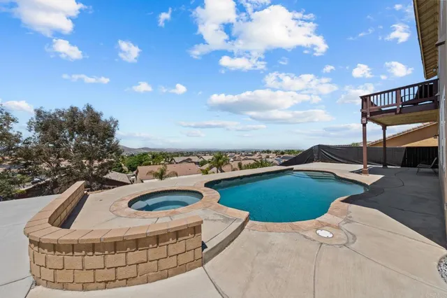 an aerial view of a house with a backyard