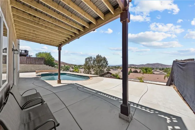 a view of a room with window and ceiling fan