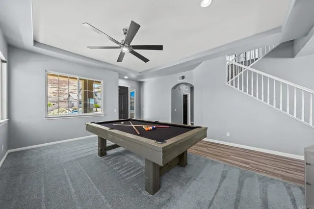 a spacious bedroom with a bed and a ceiling fan