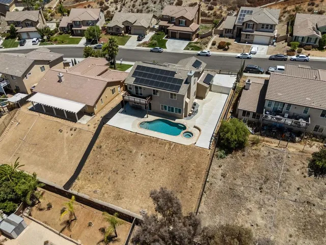 a large kitchen with a sink and dishwasher with wooden floor