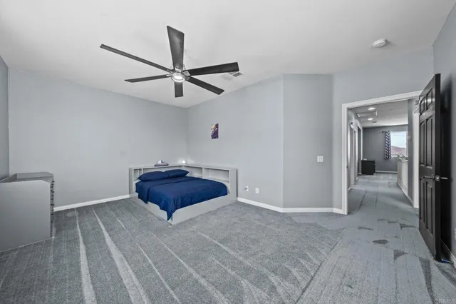 a front view of a house with a garden and plants