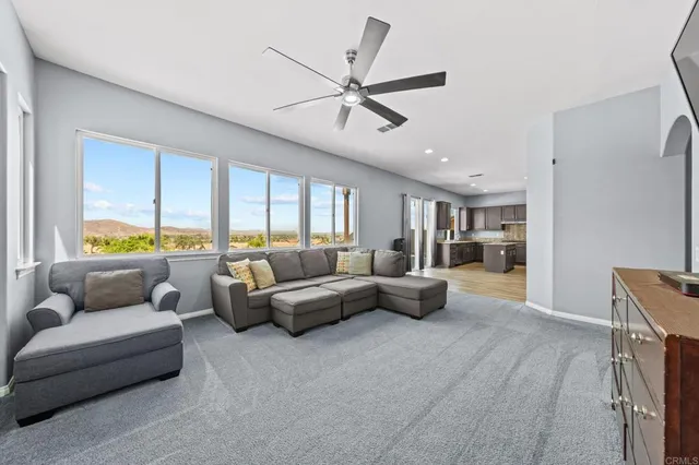 a view of a hallway with wooden floor and a window