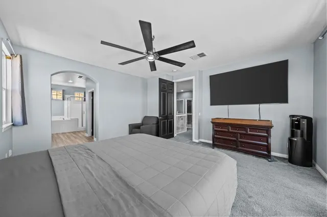 a spacious bathroom with a granite countertop sink mirror and shower