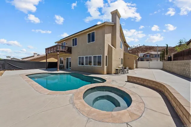 a large white kitchen with wooden floors stainless steel appliances and a counter top space