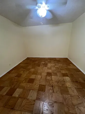 a view of a hallway with a chandelier fan and wooden floor