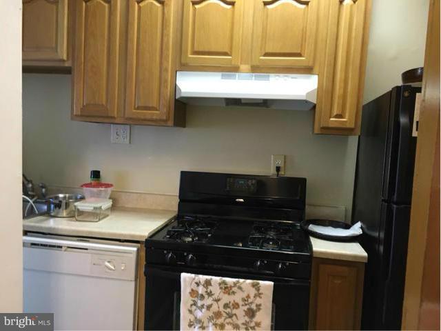 1015 Quebec Place Northwest Washington, DC 20010 - Photo 7 of 15 a kitchen with stainless steel appliances granite countertop a stove a refrigerator and a microwave
