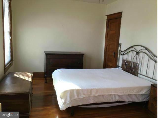 1015 Quebec Place Northwest Washington, DC 20010 - Photo 10 of 15 a bedroom with a bed and a lamp