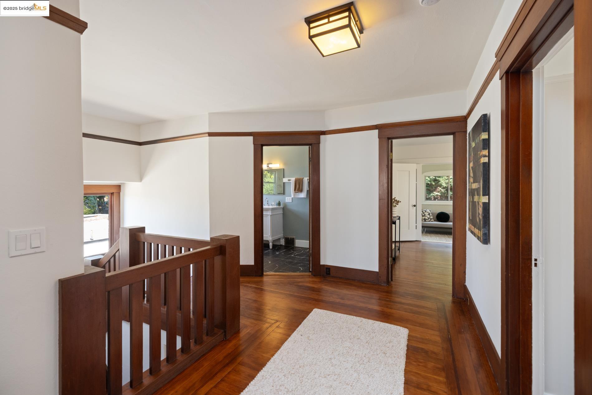 971 Santa Barbara Road Berkeley, CA 94707 - Photo 14 of 37 a view of a hallway with wooden floor and windows