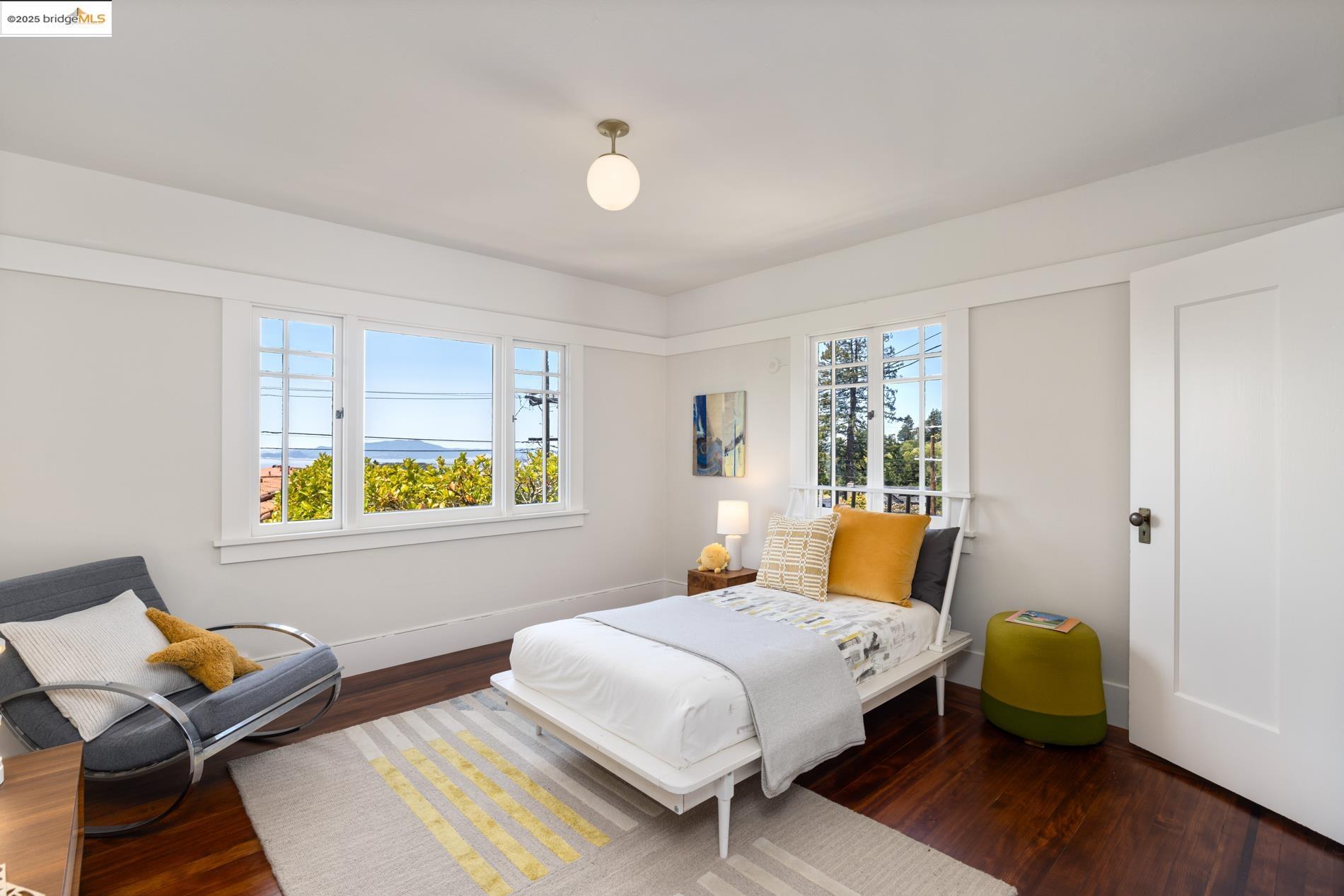 971 Santa Barbara Road Berkeley, CA 94707 - Photo 15 of 37 a bedroom with a bed and wooden floor