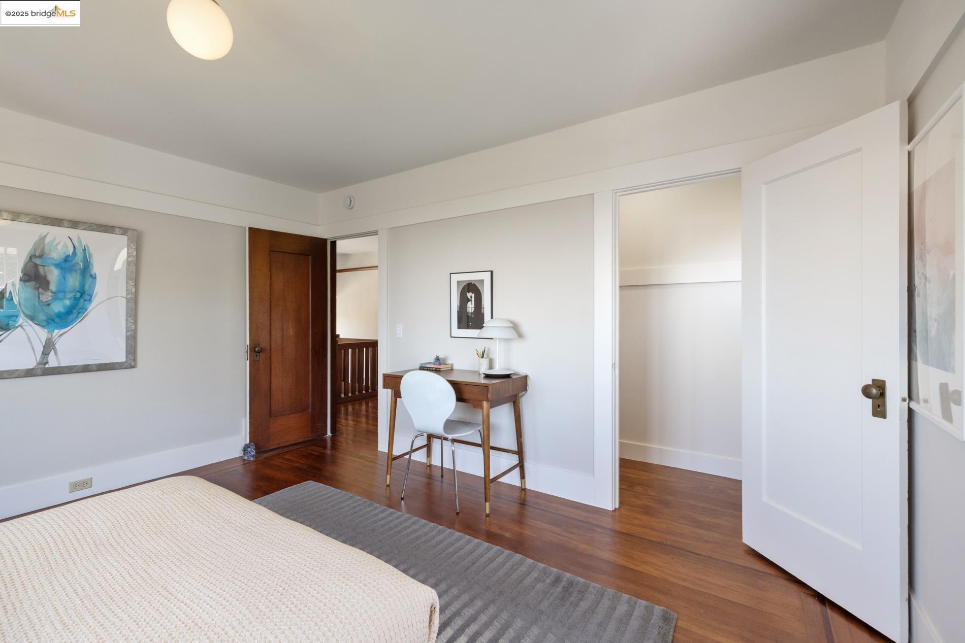 971 Santa Barbara Road Berkeley, CA 94707 - Photo 16 of 37 a bedroom with a bed and wooden floor