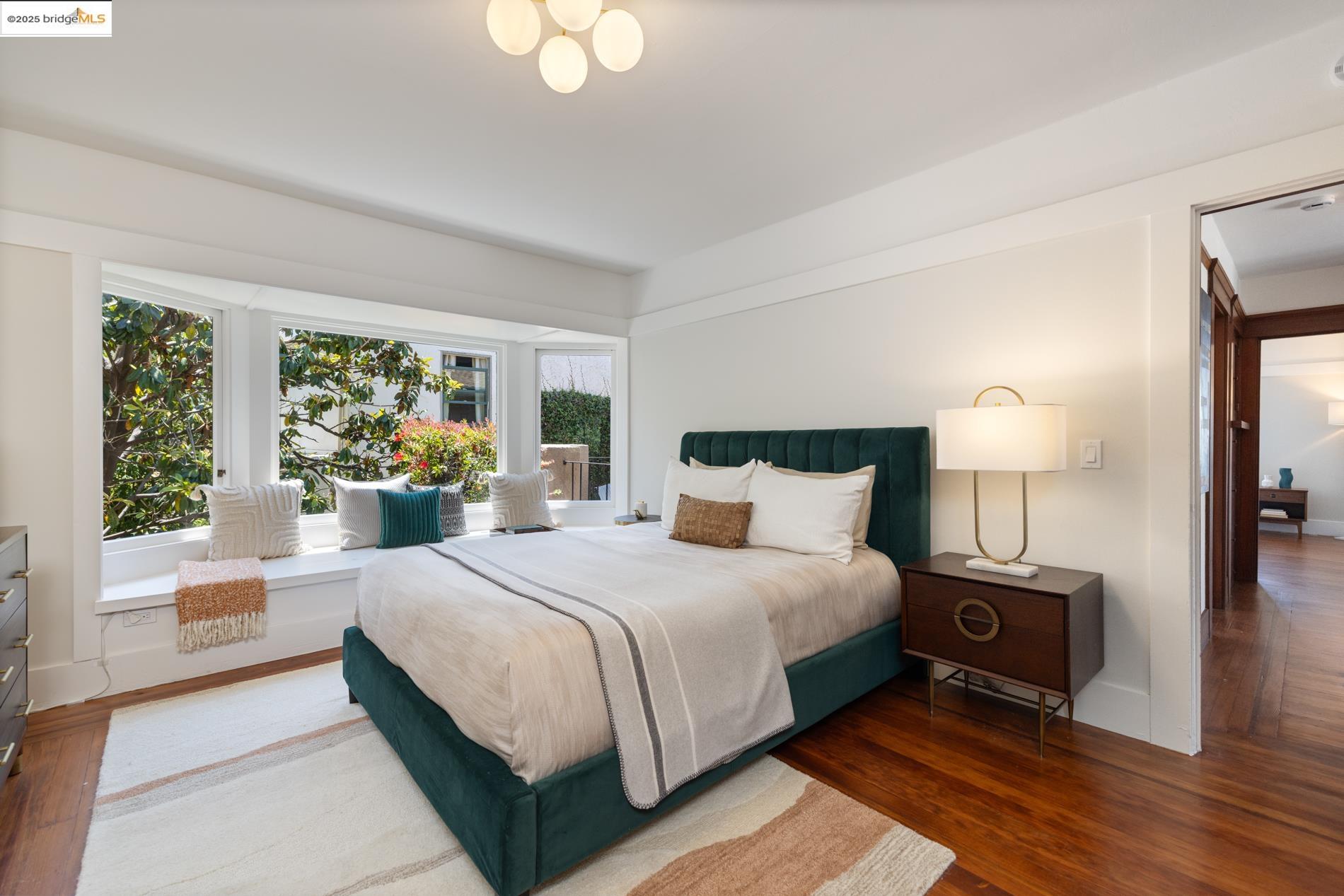 971 Santa Barbara Road Berkeley, CA 94707 - Photo 24 of 37 a bedroom with a bed and wooden floor