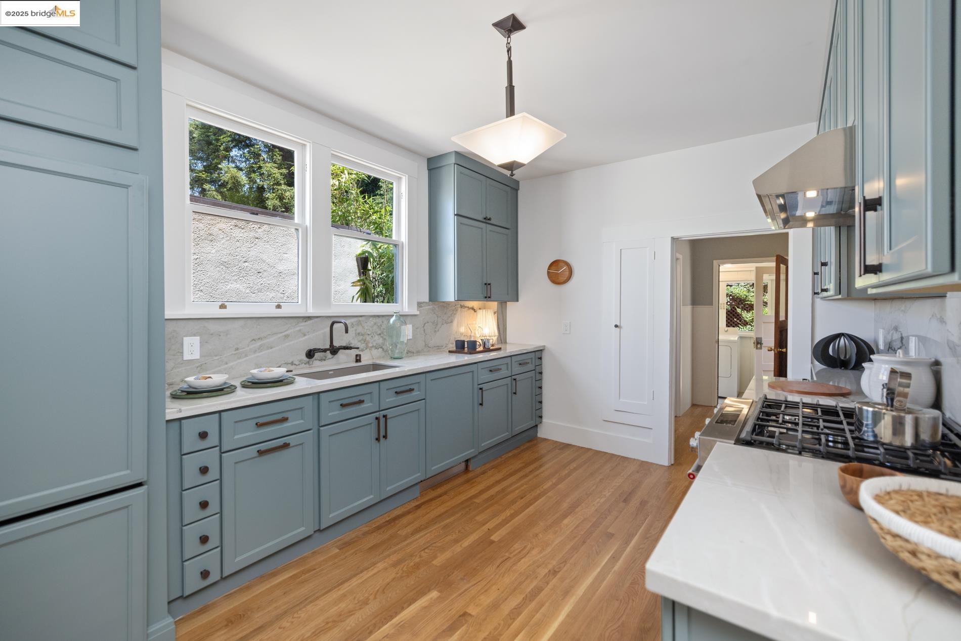 971 Santa Barbara Road Berkeley, CA 94707 - Photo 6 of 37 a large kitchen with a window and stainless steel appliances
