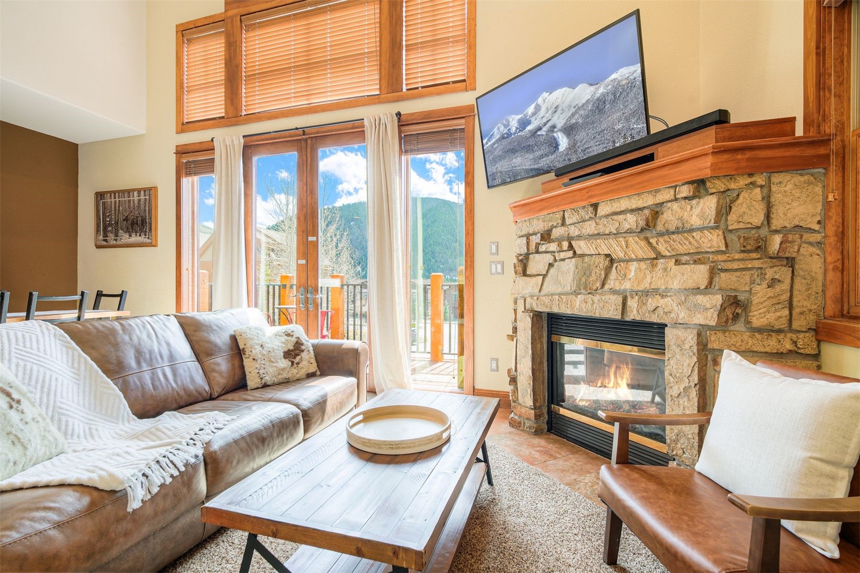 71 Antlers Gulch Road, Unit 303 Keystone, CO 80435 - Photo 4 of 35 a living room with furniture and a fireplace