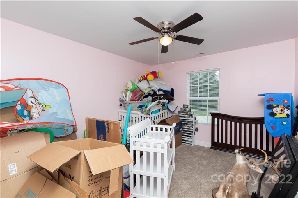 2993 Greenleaf Road Clover, SC 29710 - Photo 17 of 27 a bedroom with furniture and a chandelier