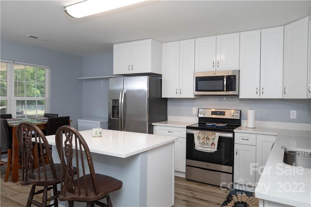 2993 Greenleaf Road Clover, SC 29710 - Photo 6 of 27 a kitchen with stainless steel appliances a stove a sink a microwave a refrigerator and cabinets
