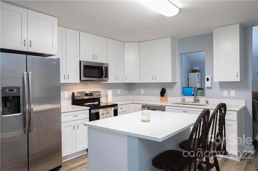 2993 Greenleaf Road Clover, SC 29710 - Photo 8 of 27 a kitchen with stainless steel appliances a refrigerator stove microwave and cabinets