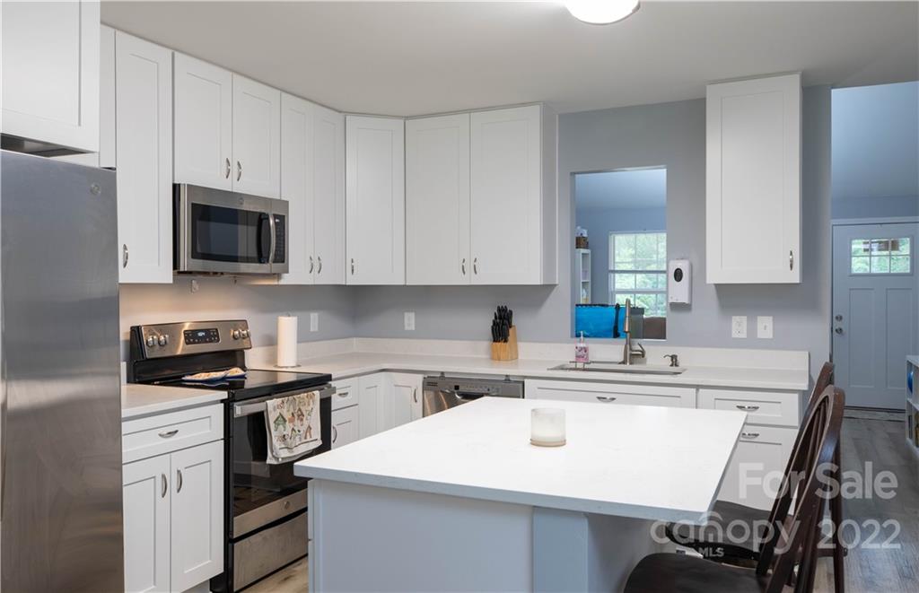 2993 Greenleaf Road Clover, SC 29710 - Photo 9 of 27 a kitchen with stainless steel appliances a sink a stove a refrigerator cabinets and a counter space
