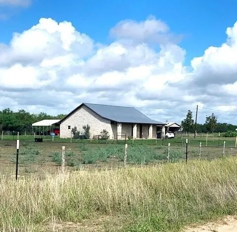 a view of a lake with a big yard and potted plants