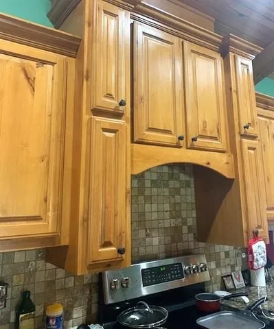 a kitchen with granite countertop cabinets and has wooden floor