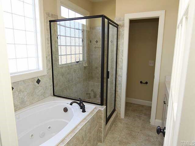 1327 Ileagnes Road Raleigh, NC 27603 - Photo 11 of 21 Wow! Look at the beautifull travertine tile in this master bath with separate shower and whirlpool tub. Get the candles and the bubble bath!