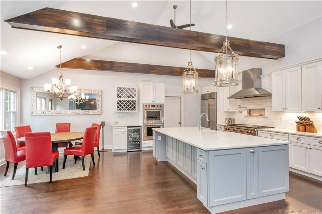 489 Roxbury Road Stamford, CT 06902 - Photo 1 of 1 a large white kitchen with a stove a table and chairs