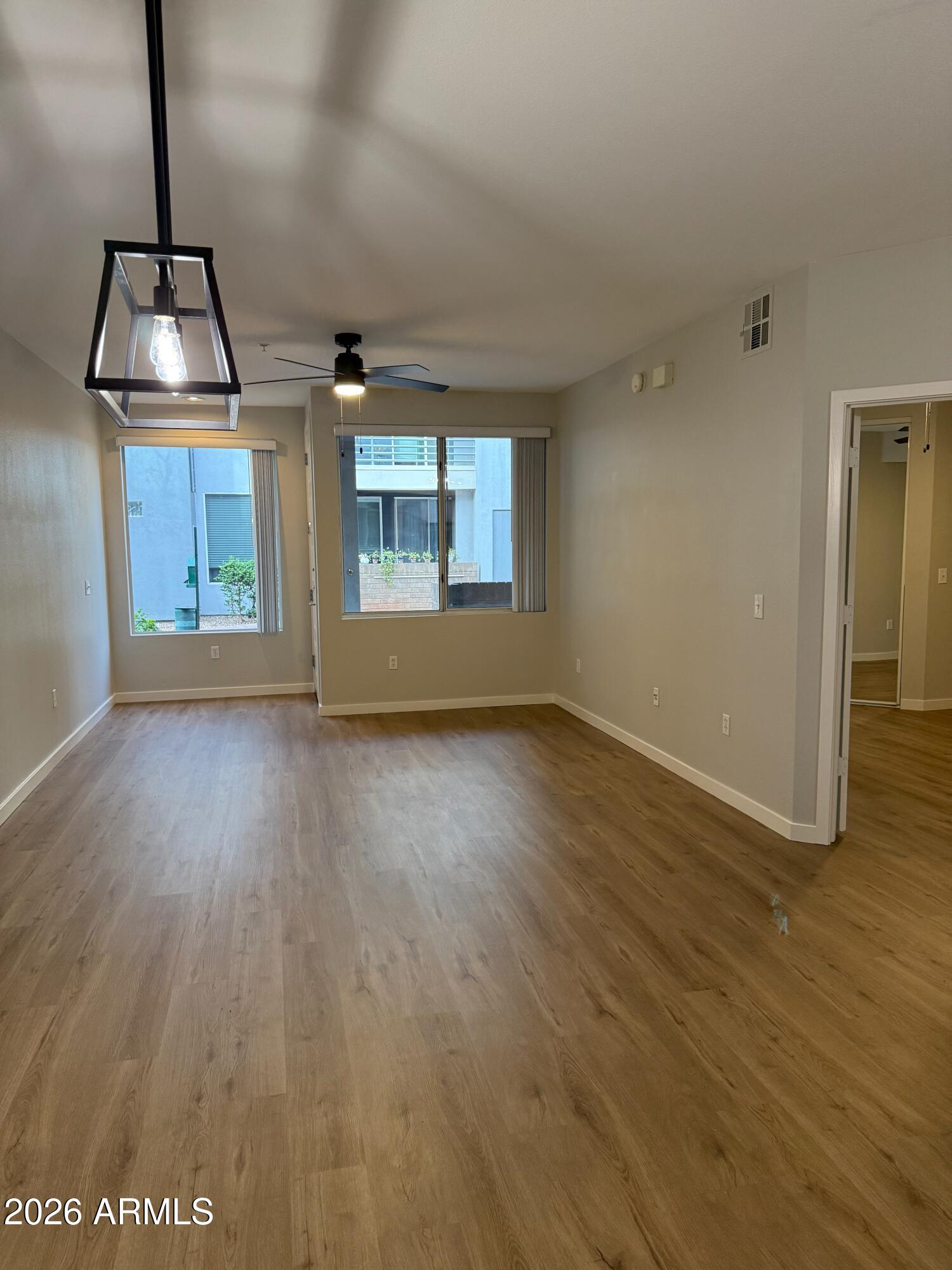 3633 North 3rd Avenue, Unit 1043 Phoenix, AZ 85013 - Photo 6 of 14 a view of a room with wooden floor staircase and a kitchen