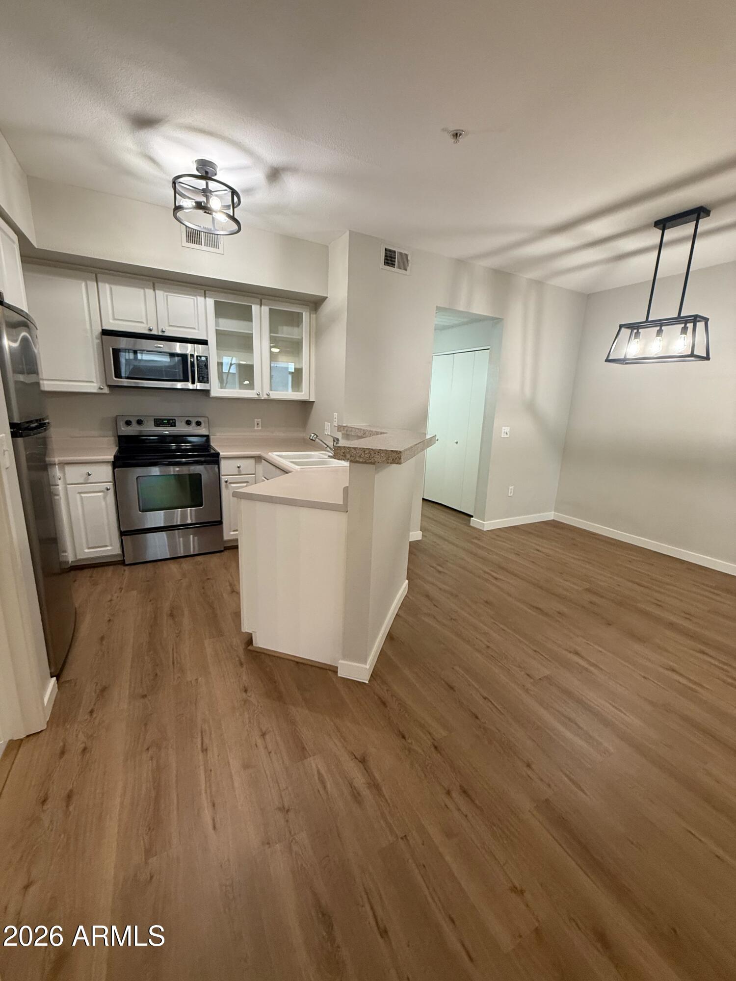 3633 North 3rd Avenue, Unit 1043 Phoenix, AZ 85013 - Photo 7 of 14 a kitchen with a sink and a stove top oven