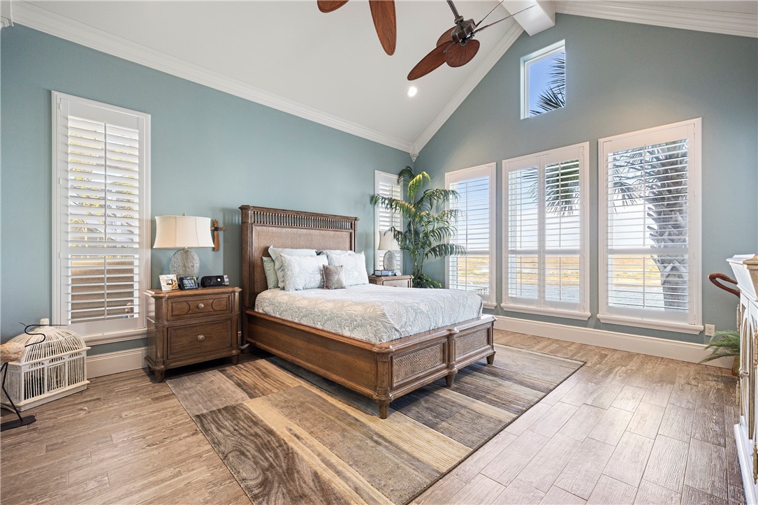 13806 Captains Row Corpus Christi, TX 78418 - Photo 14 of 40 a bedroom with a large bed and a large window